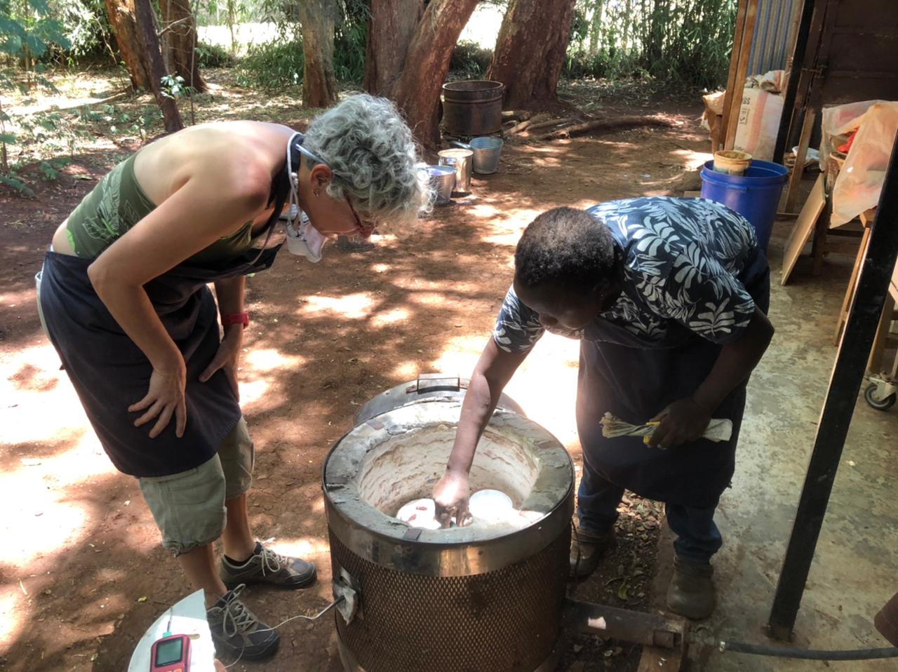 Packing the Raku kiln with Waithira Chege & students